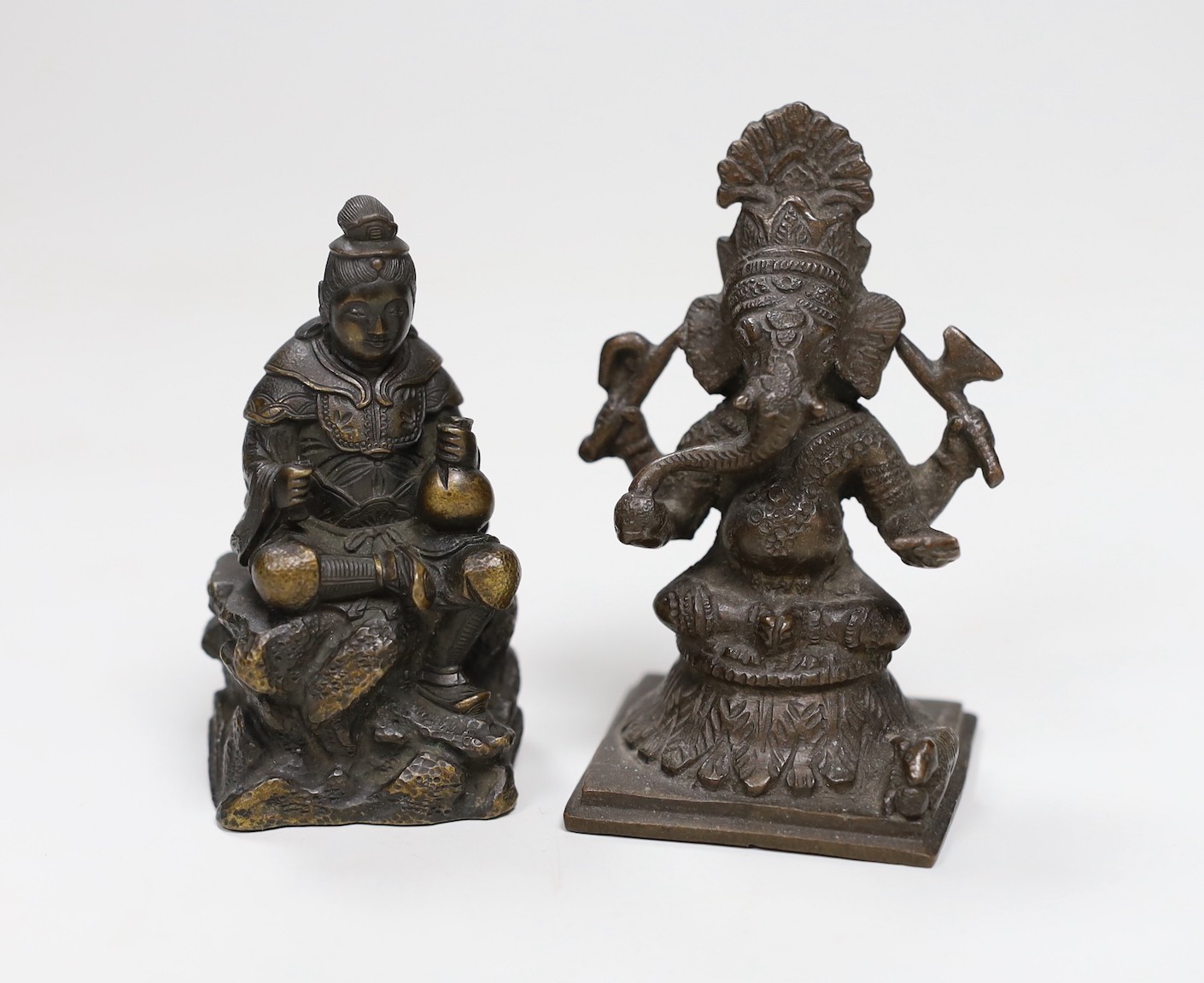 A Japanese Meiji period bronze of a seated figure, inscription to base together with an Indian bronze of Ganesh, tallest 8cms high